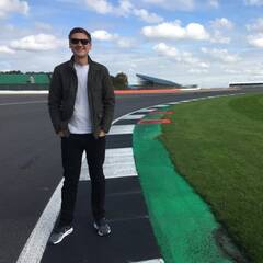 Photograph of Andrew Wilson standing on a race track